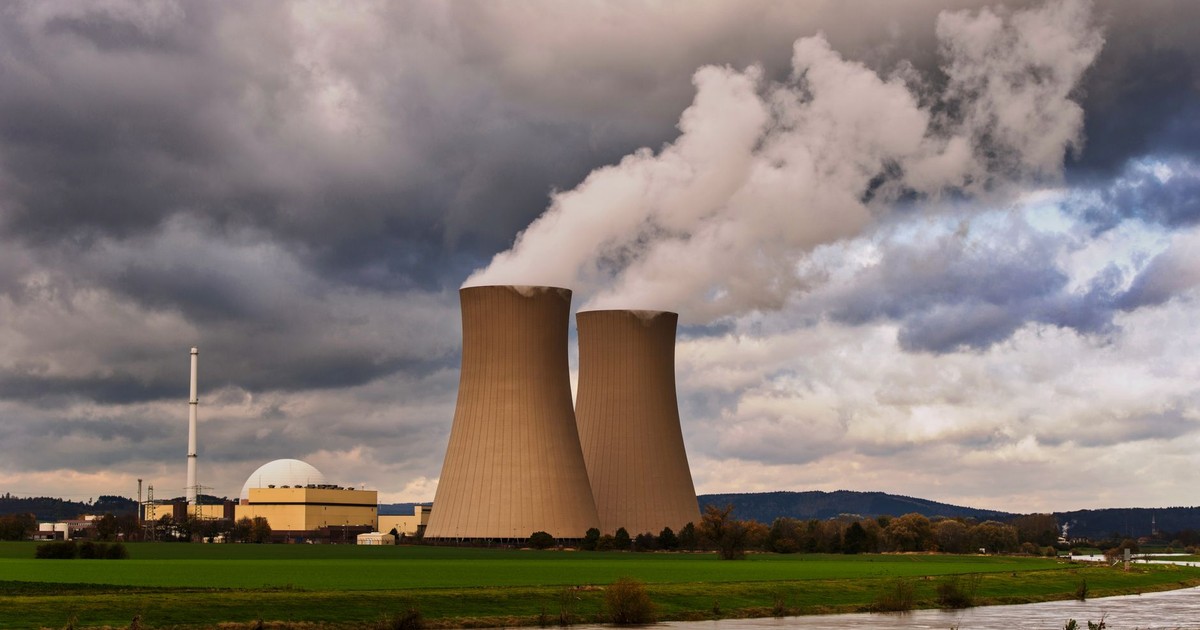 Scenic view of a nuclear power plant with cooling towers emitting steam in Hameln, Germany.