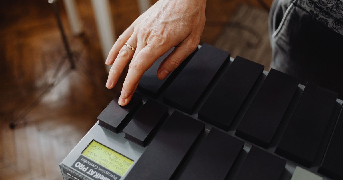 Close-up of a hand playing the MalletKat electronic percussion instrument indoors.