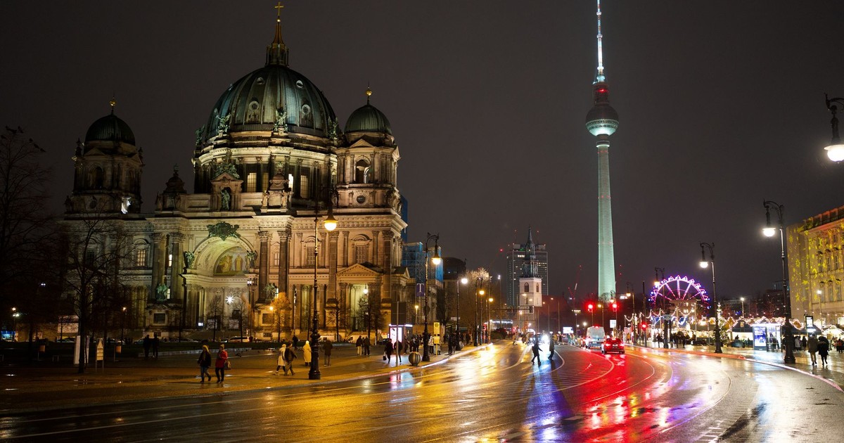 A captivating night scene featuring Berlin Cathedral and Fernsehturm illuminated in Berlin, Germany.