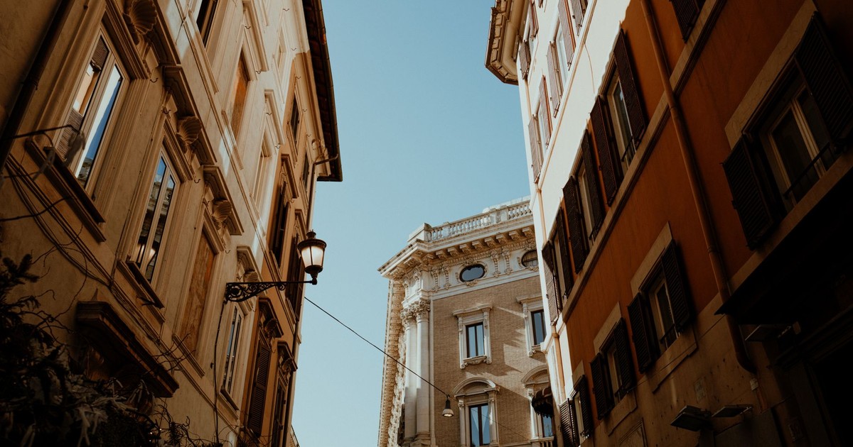 Beautiful view of Roman architecture with sunlight casting shadows between historical buildings.