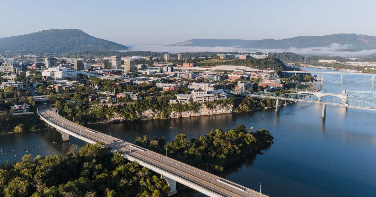 Stunning aerial view of Chattanooga's skyline with bridges and mountains in the background.