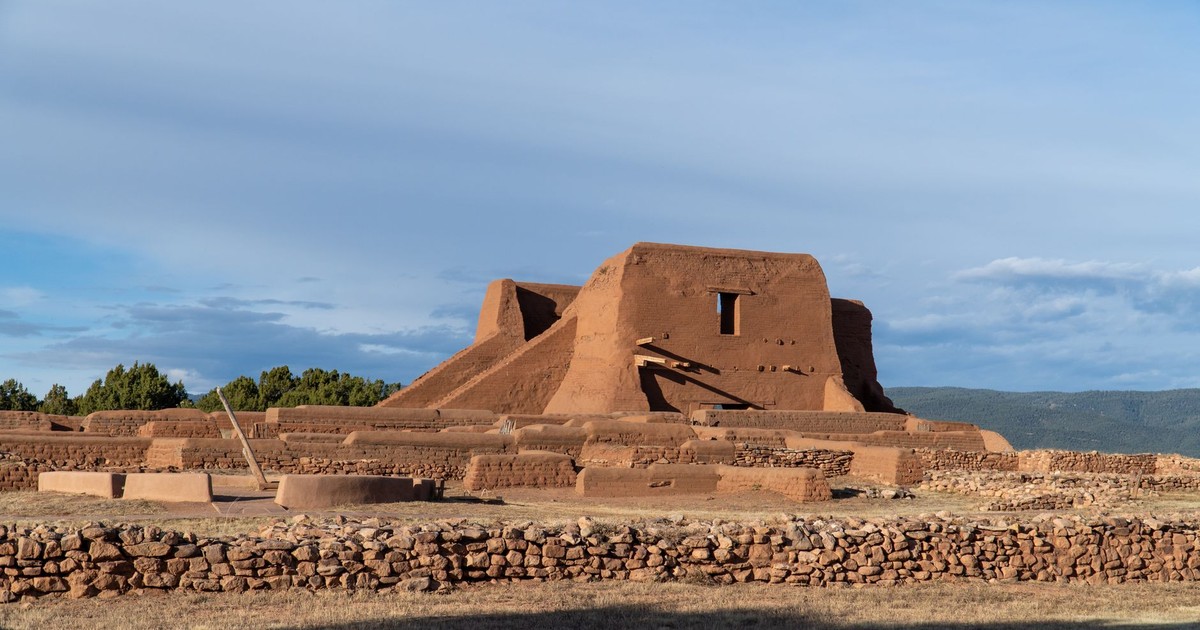 Explore ancient adobe ruins under a bright blue sky at Pecos National Historical Park, New Mexico.