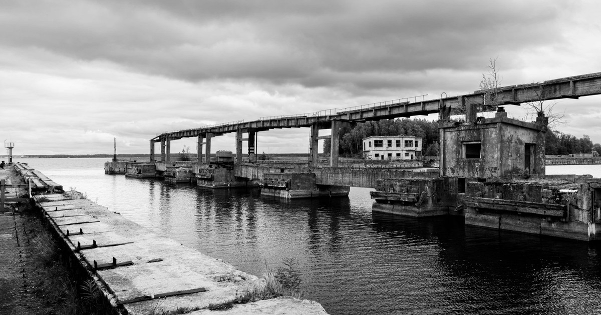 Black and white photo of abandoned Soviet submarine base in Hara, Estonia, overcast sky.