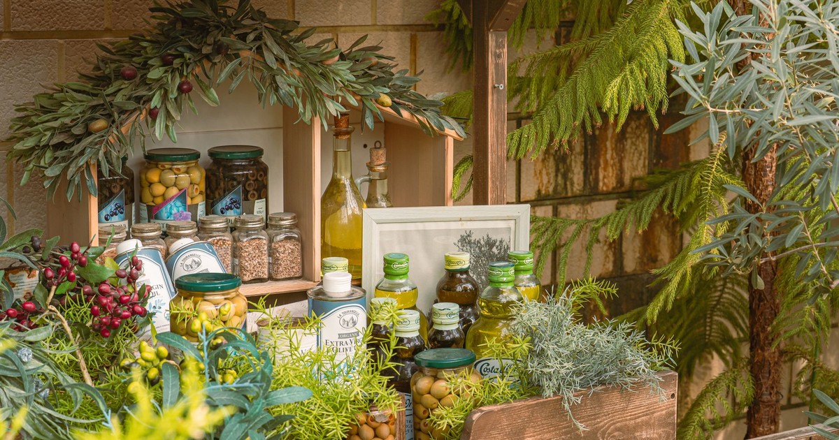 Charming outdoor display of olive oils and herbs, perfect for rustic decor enthusiasts.