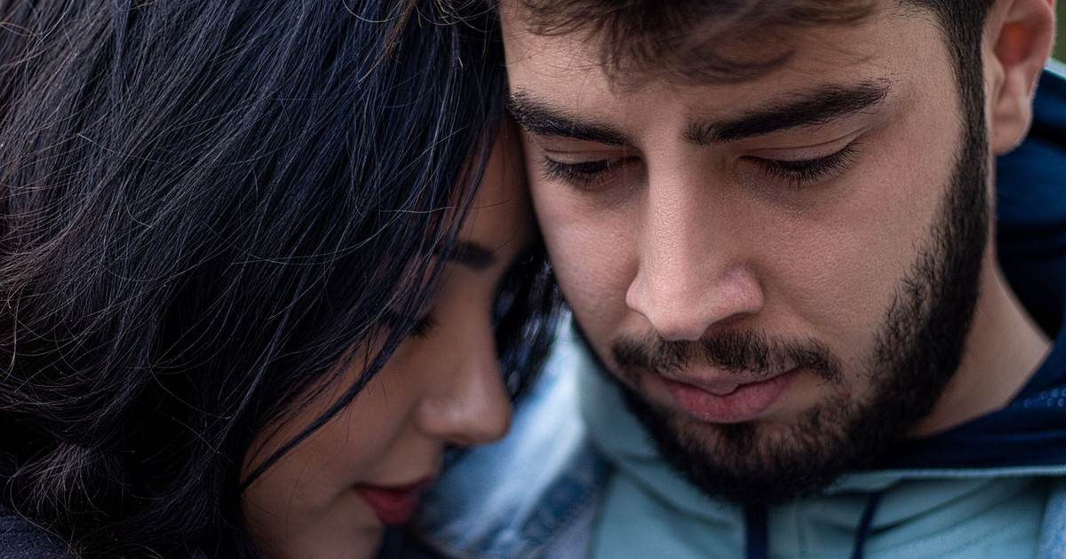 Close-up of a romantic couple sharing a tender moment outdoors.