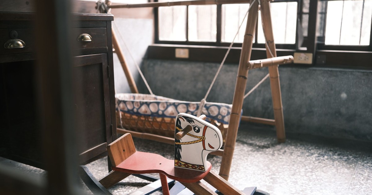 Charming vintage toy horse and cradle in a classic room setting, evoking nostalgia and childhood memories.