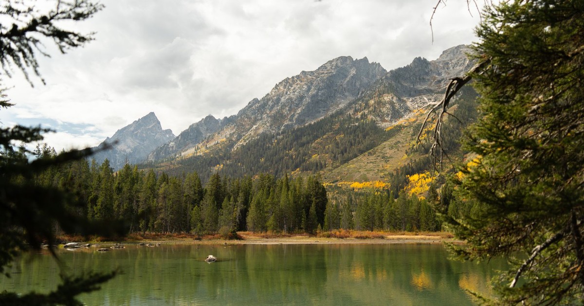 Serene autumn landscape of Grand Teton National Park with lake and mountains.