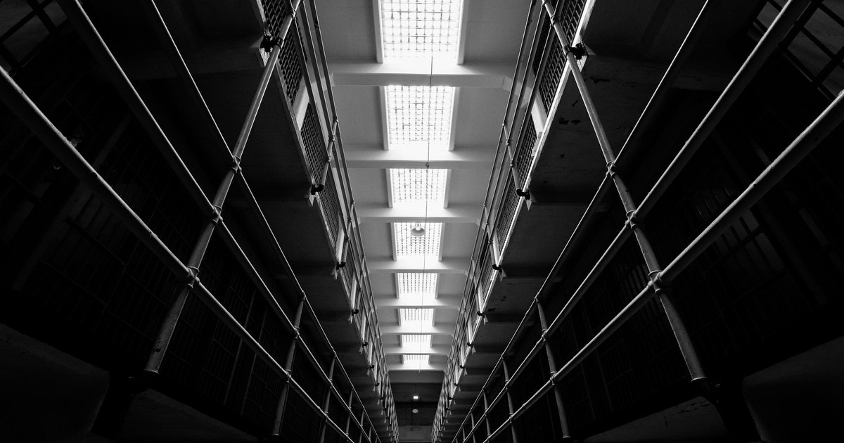 Eerie view of Alcatraz prison interiors in monochrome, showcasing the historical architecture.