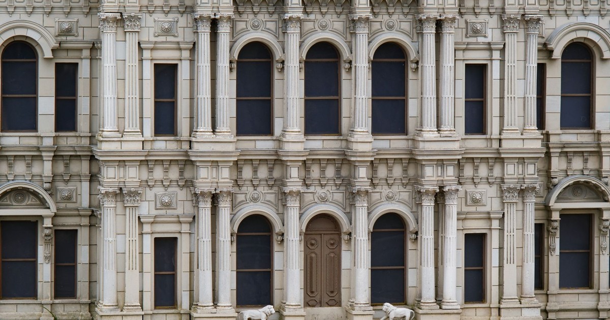Intricate facade of a historic mansion in Istanbul showcasing neoclassical architecture and classical columns.