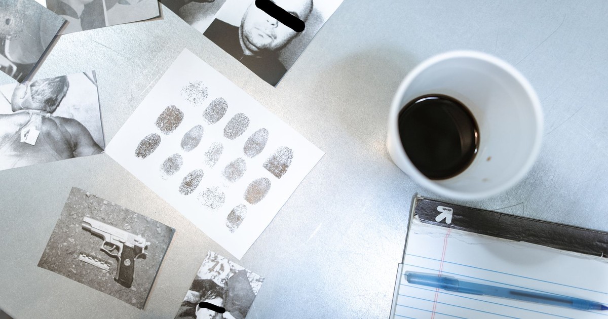 Flat lay of forensic evidence and police investigation documents on a desk.