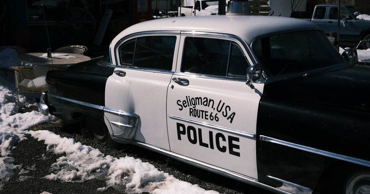 Retro police car in Seligman, Arizona, on snow-covered Route 66.