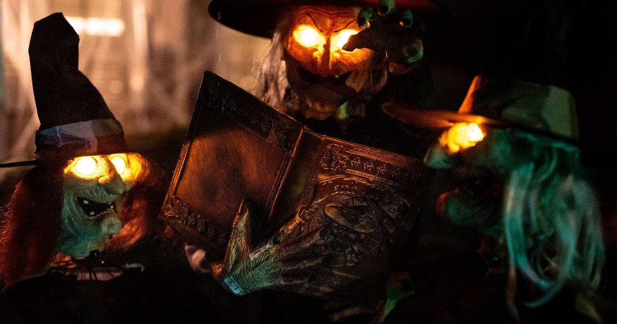 Halloween decorations featuring glowing witch figures and an eerie book in Atlanta, Georgia.