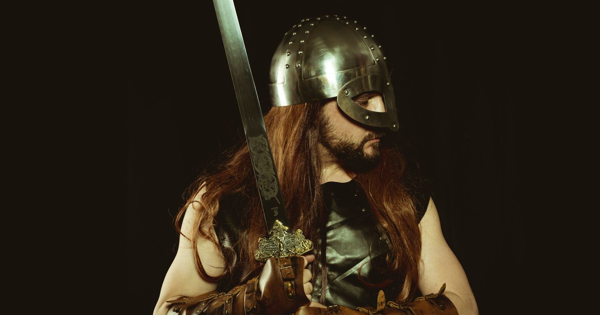 A medieval warrior wearing a helmet and leather armor, holding a sword, embodying the Viking spirit.