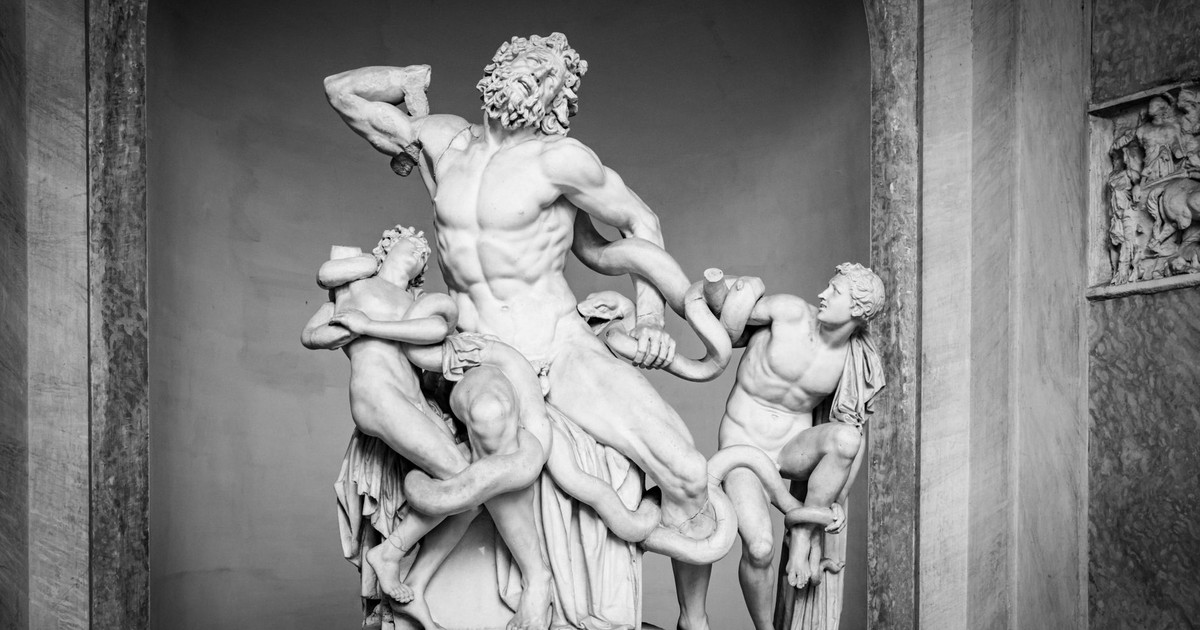 Black and white photo of the famous Laocoön and His Sons marble statue, highlighting intricate Roman art details.