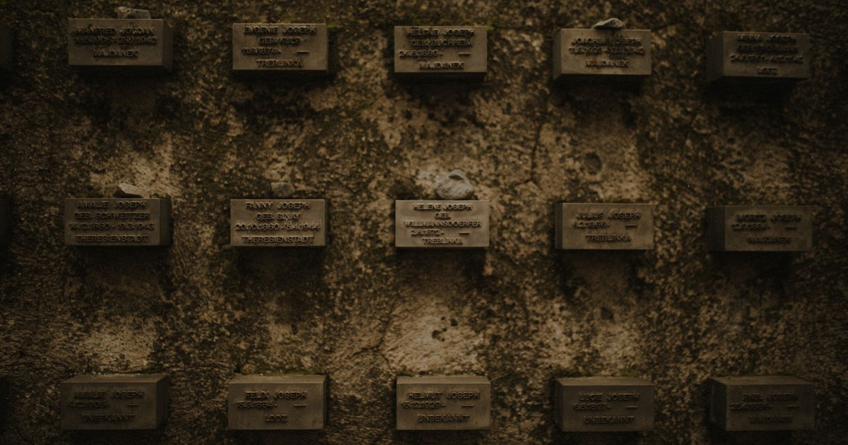 Wall of memorial plaques symbolizing remembrance of historical events.