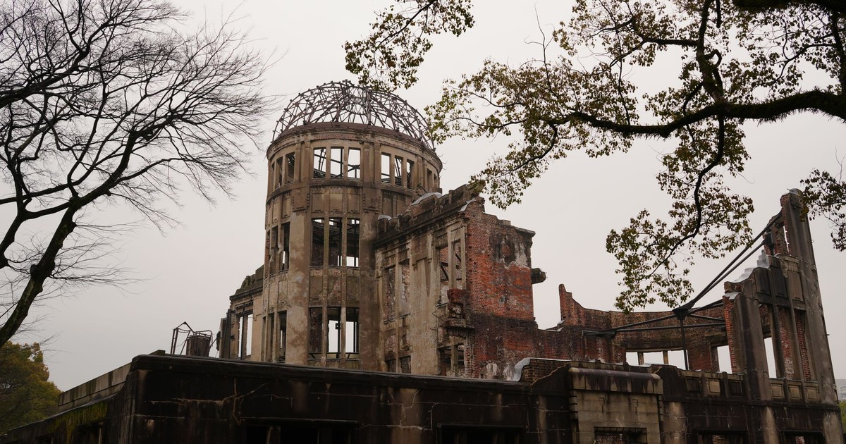 Hiroshima Peace Memorial with bare trees represents history and resilience.