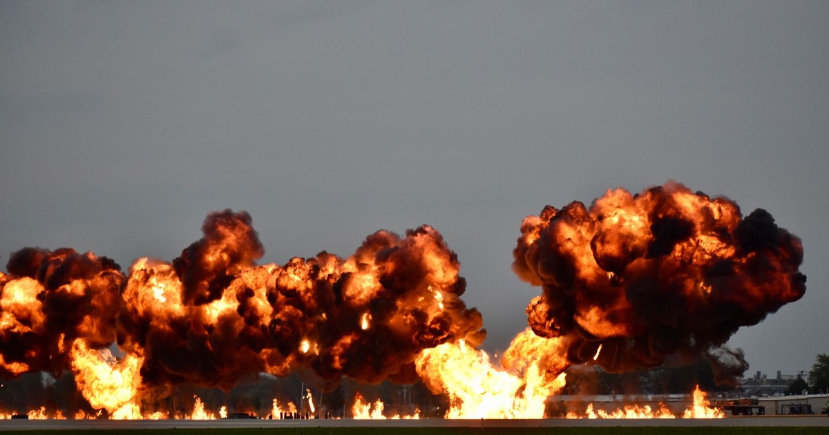 Dramatic explosion during airshow in Oshkosh, Wisconsin showcasing flames and smoke.