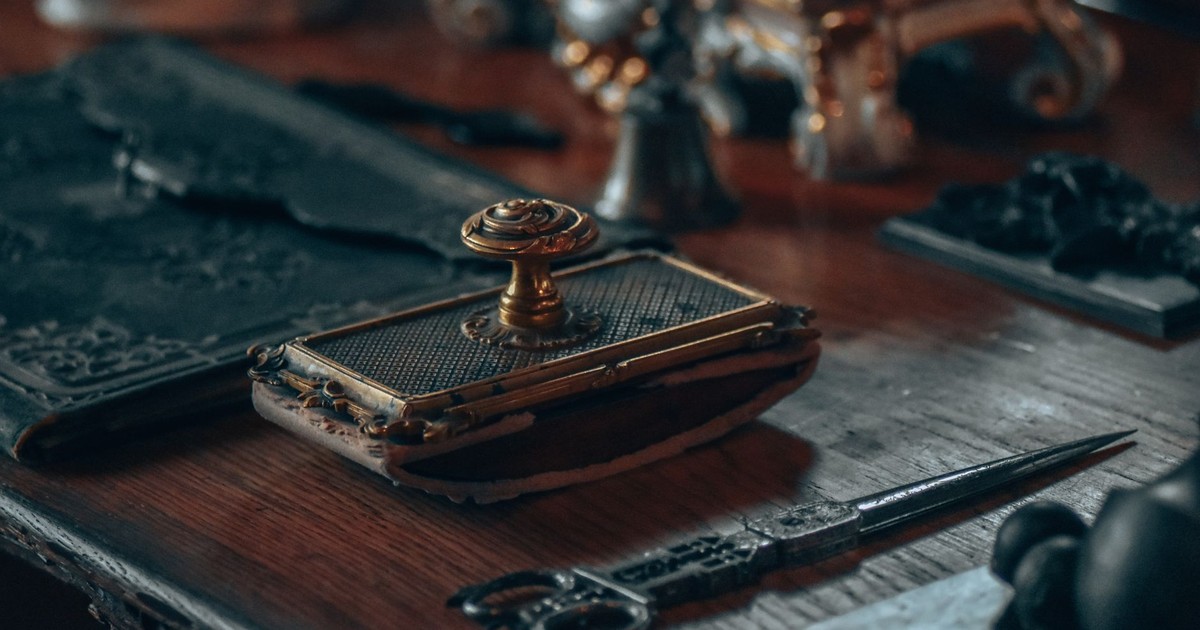 A close-up of a vintage desk with intricate antique objects, offering a nostalgic vibe.