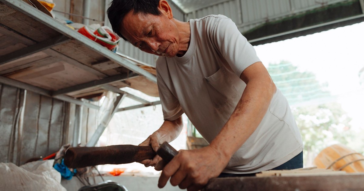 Elderly man skillfully working with wood in workshop setting, showcasing traditional craftsmanship.