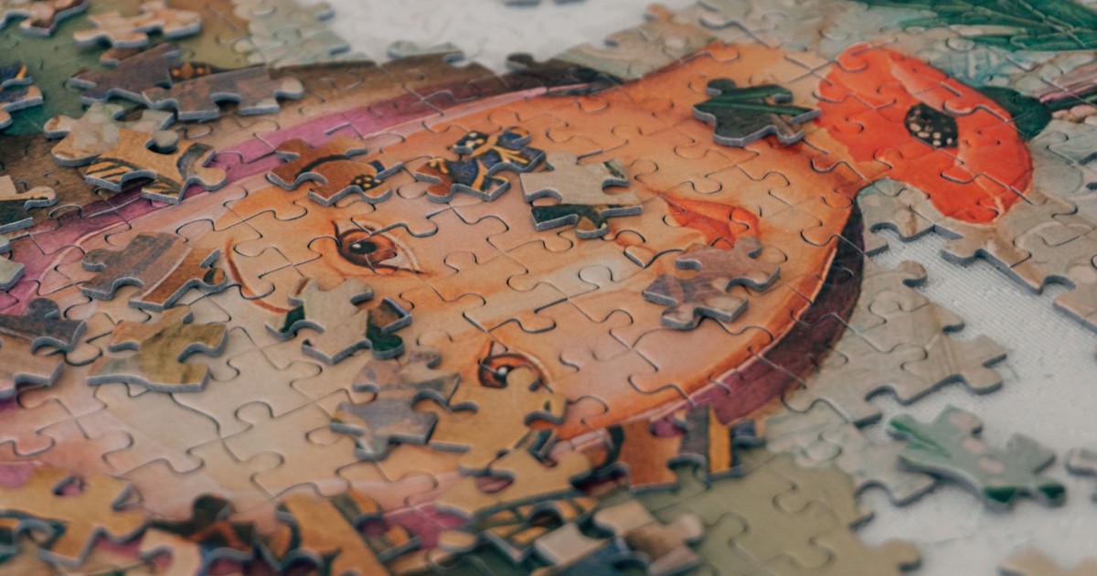 Close-up of a partially completed portrait puzzle, showcasing vivid colors and intricate details.