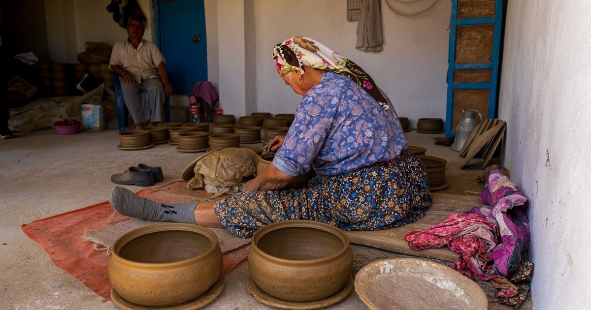 Woman crafting pottery in a rustic workshop, showcasing traditional techniques and cultural heritage.