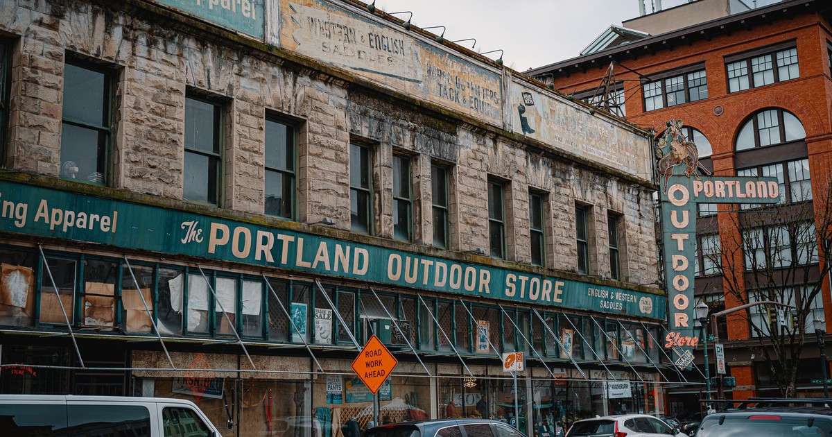 Street view of the iconic Portland Outdoor Store with vintage signage and urban scenery.