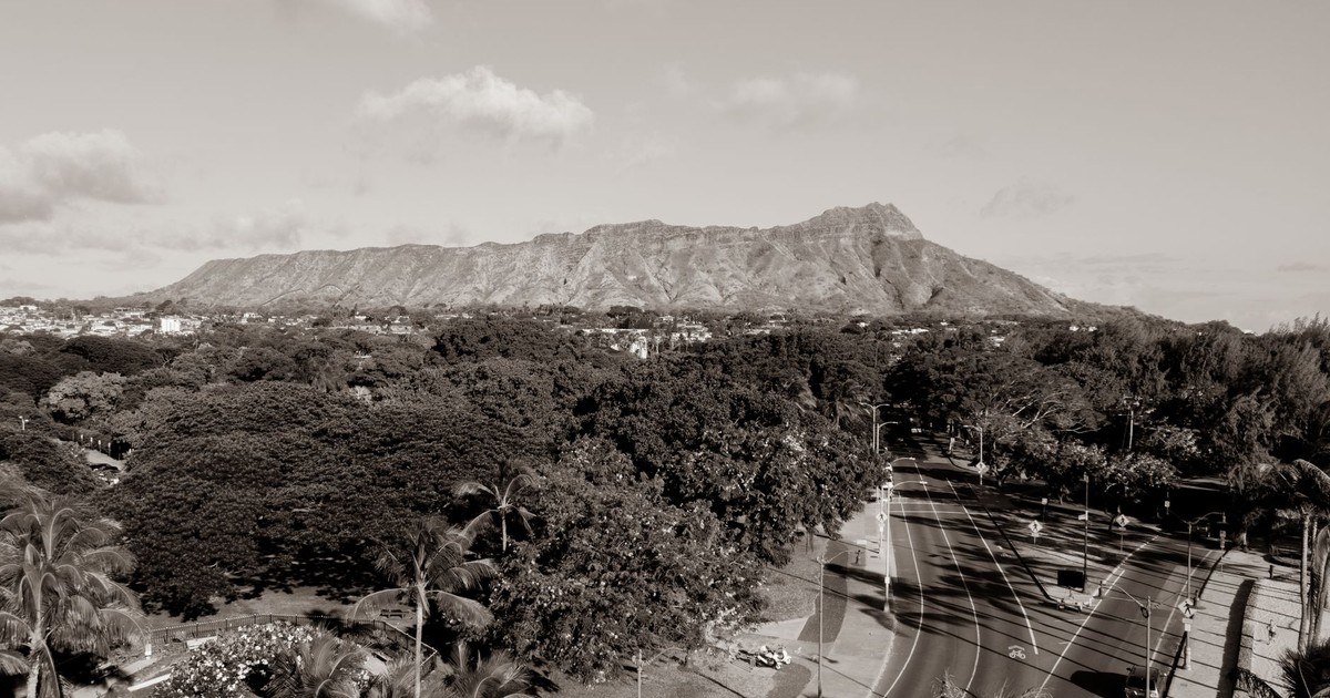 Black and white aerial photo showcasing Diamond Head with roads and palm trees in Hawaii.