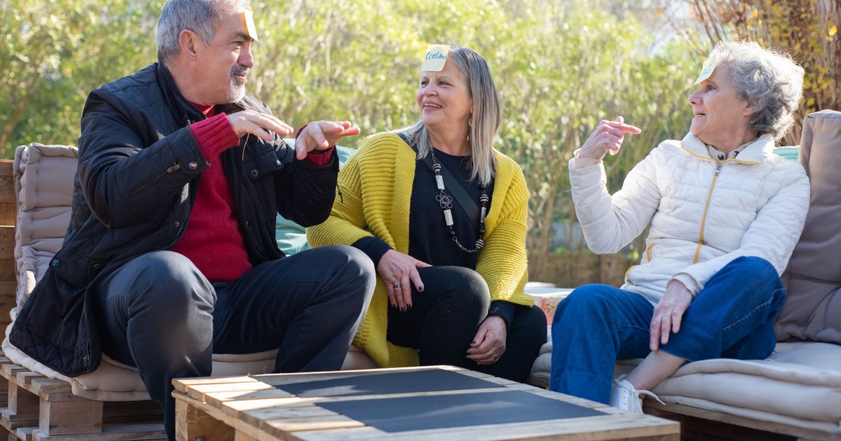 Three happy senior adults enjoying a fun game outdoors, embracing positive aging.
