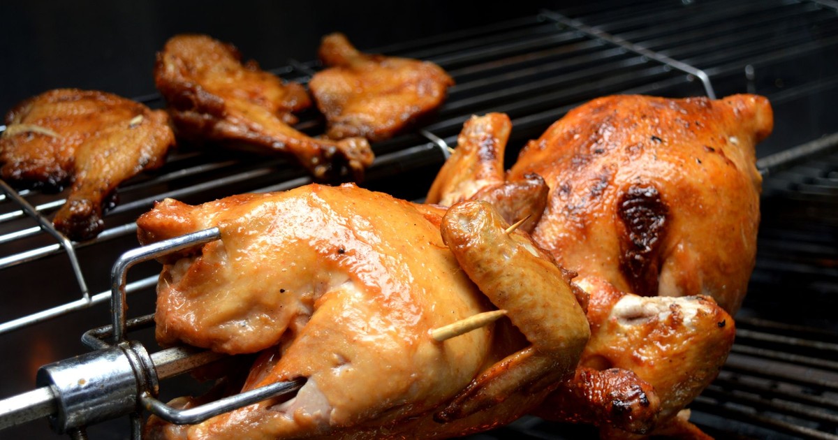 Juicy roasted chicken cooked on a grill, showcasing mouthwatering food photography.