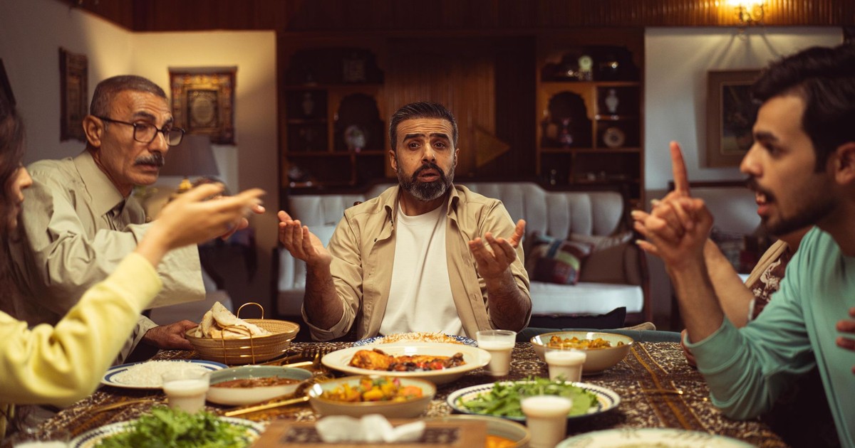A family engaging in conversation over a traditional meal, fostering connection.