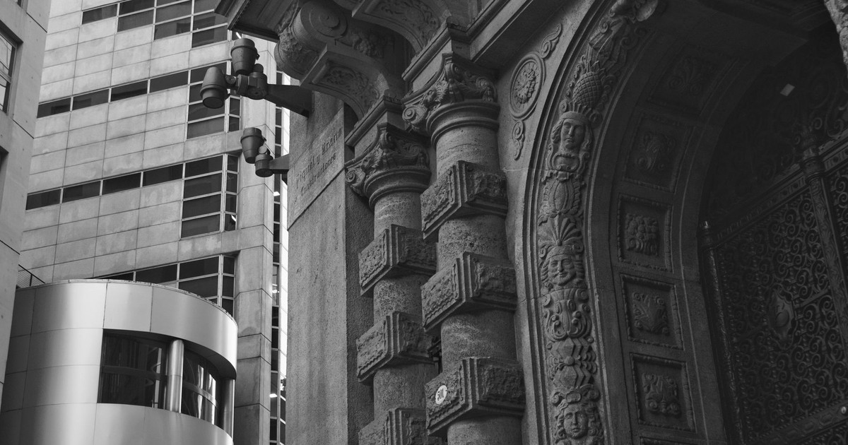 Ornate historic facade contrasts with modern skyscraper in Buenos Aires, CABA, Argentina.