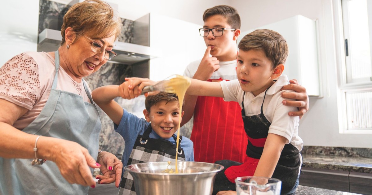 Grandmother and grandsons enjoy baking together, creating special memories in the kitchen.