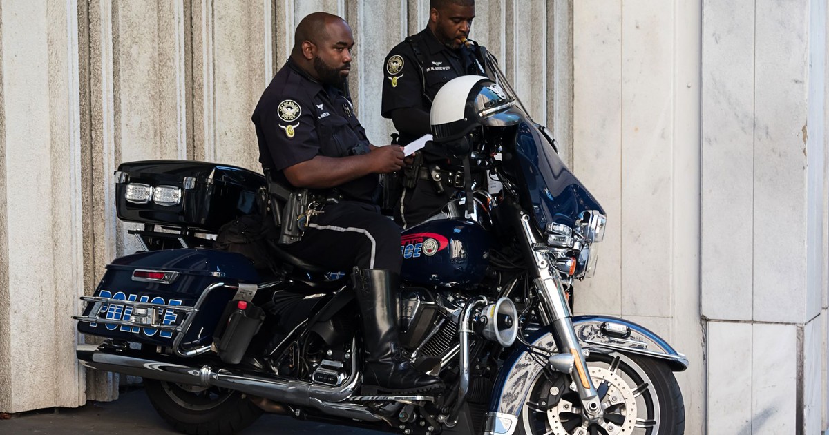 Police officers on a motorbike in Atlanta, showcasing law enforcement in action.