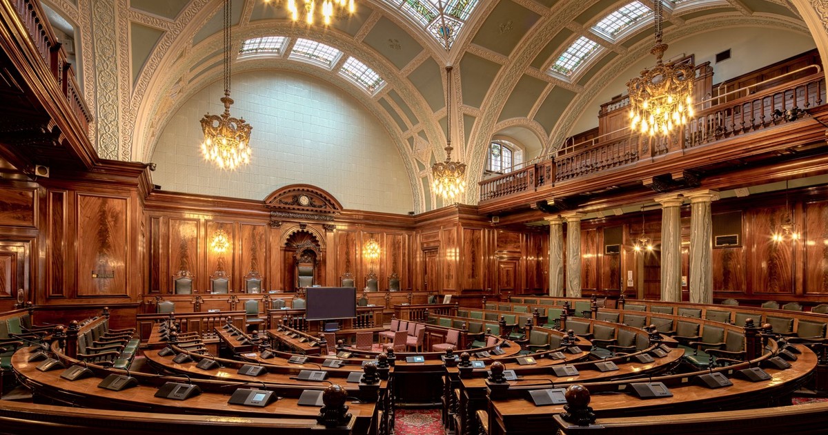 A beautifully designed chamber room with ornate woodwork and chandeliers in the UK.