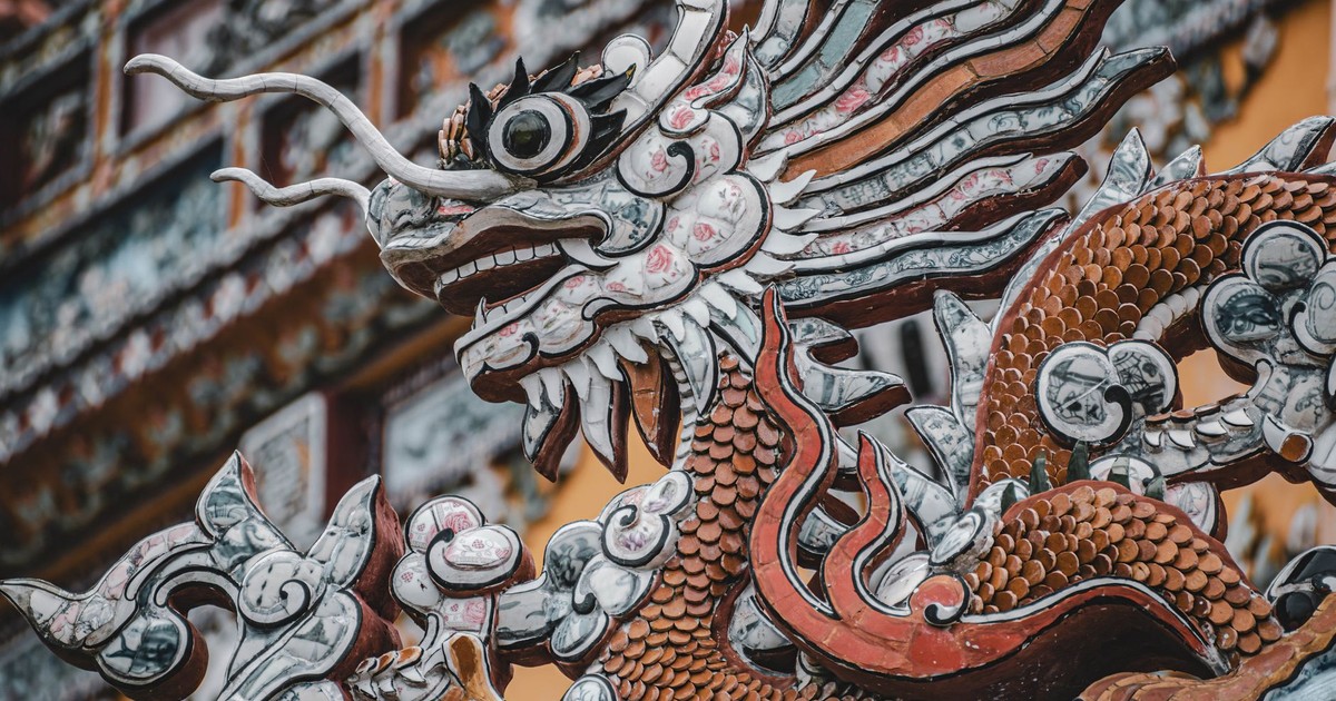 Close-up of a detailed dragon sculpture in a traditional Chinese temple setting.