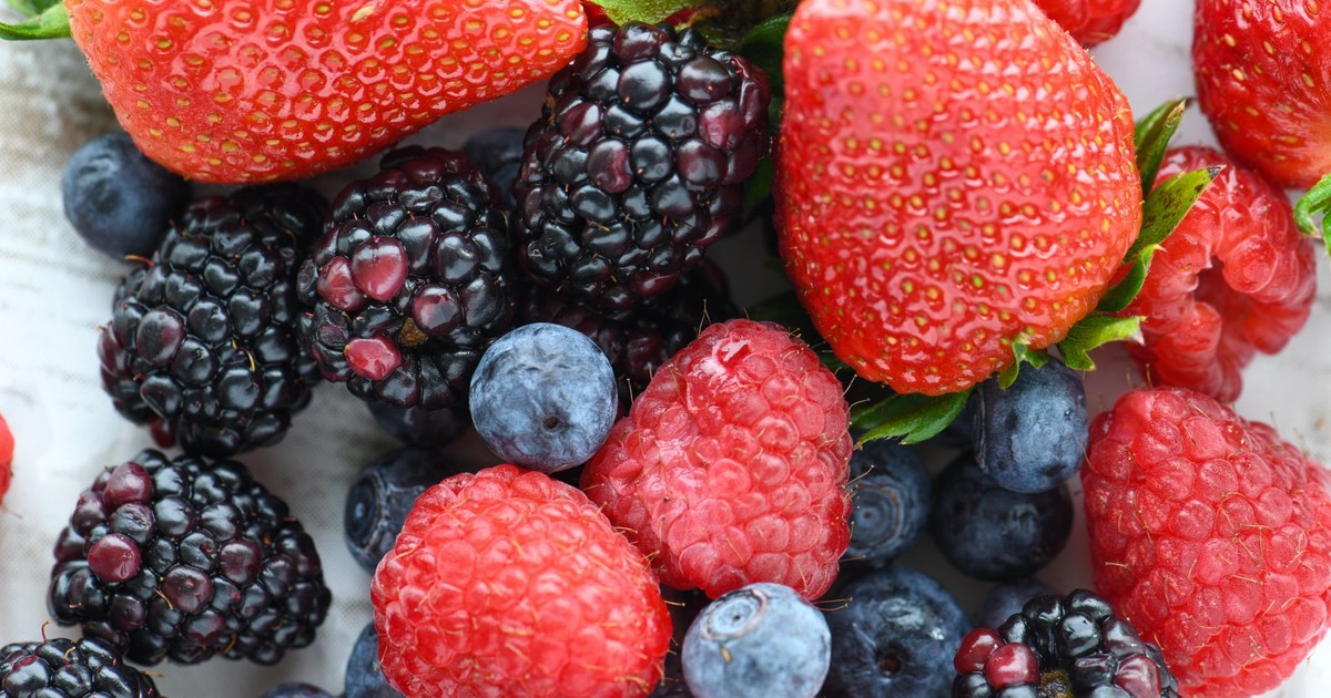 A vibrant close-up of fresh strawberries, raspberries, blackberries, and blueberries.
