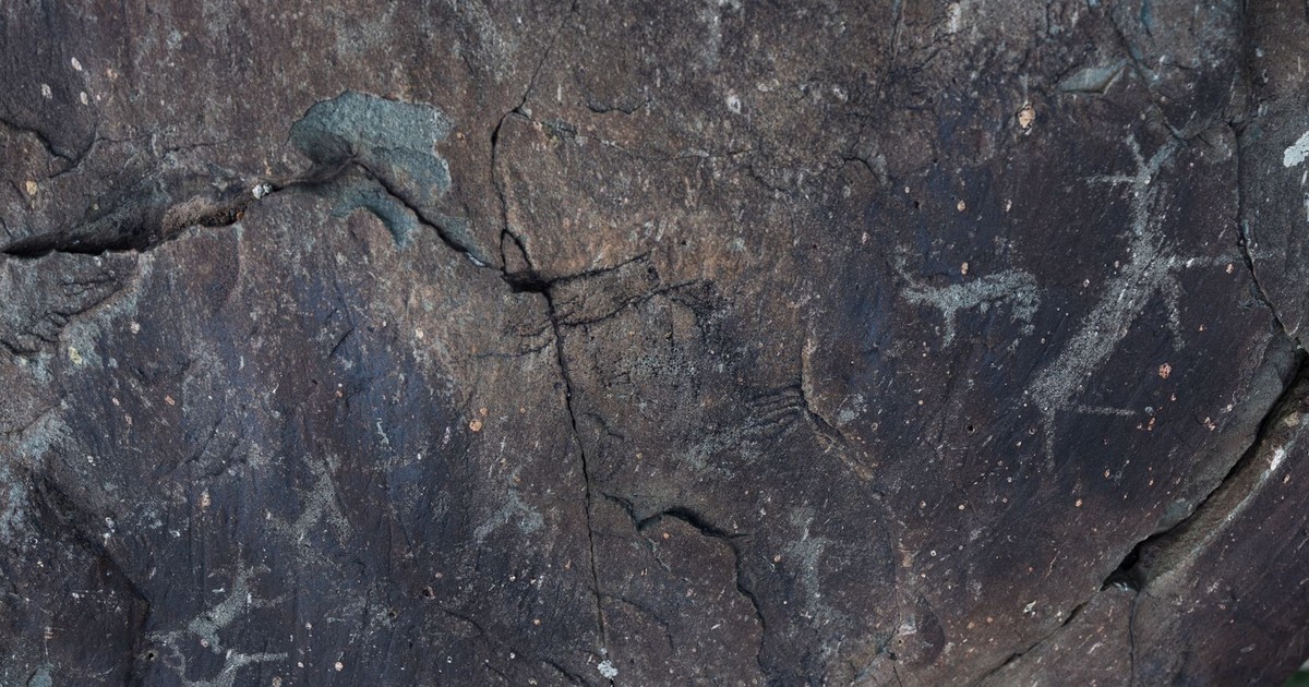 From above of dark gray natural slope with shabby surface and tiny aged paintings
