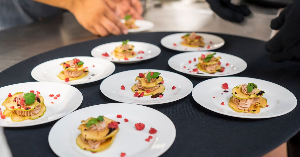A chef's creative presentation of gourmet appetizers on elegant plates. Shot from above.