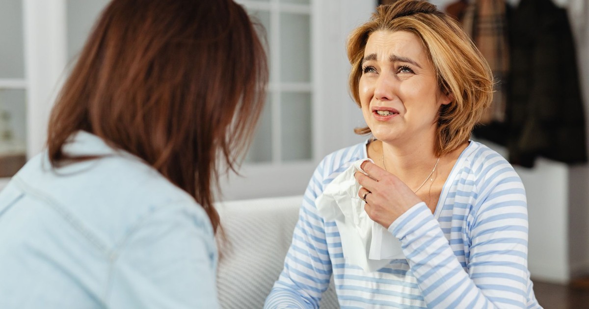 A woman receiving comfort from a friend, illustrating empathy and support in a difficult moment.