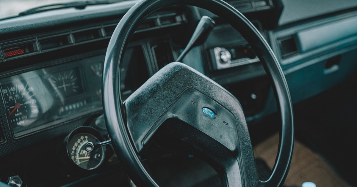 Explore the classic design of a vintage car interior featuring a retro steering wheel and dashboard.