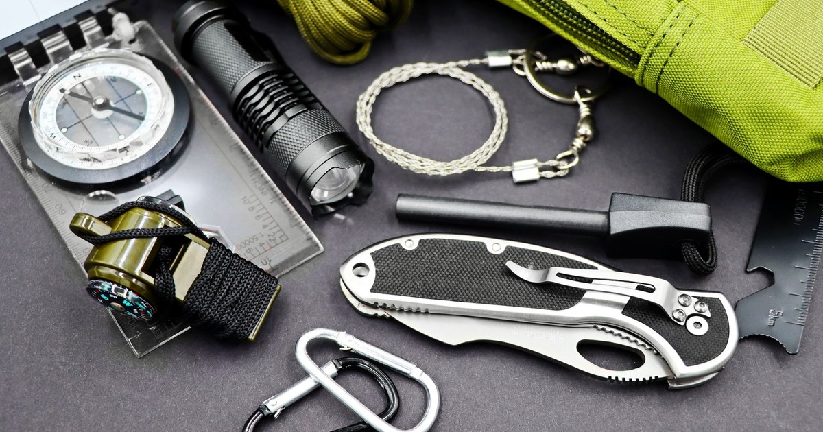 A comprehensive layout of essential survival tools including compass, flashlight, and knife, perfect for outdoor adventures.
