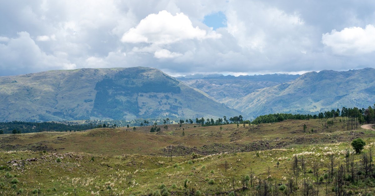 Beautiful view of rolling hills and mountains under a cloudy sky in Córdoba, Argentina.