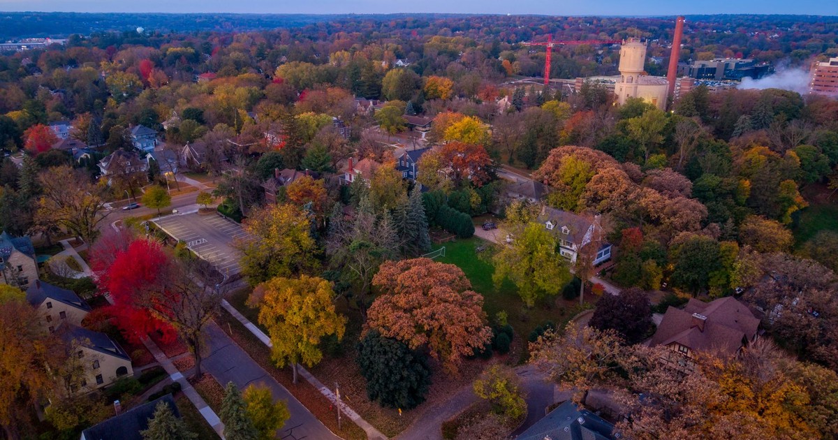 A stunning aerial view of Rochester, Minnesota, showcasing vibrant fall foliage in a residential area.