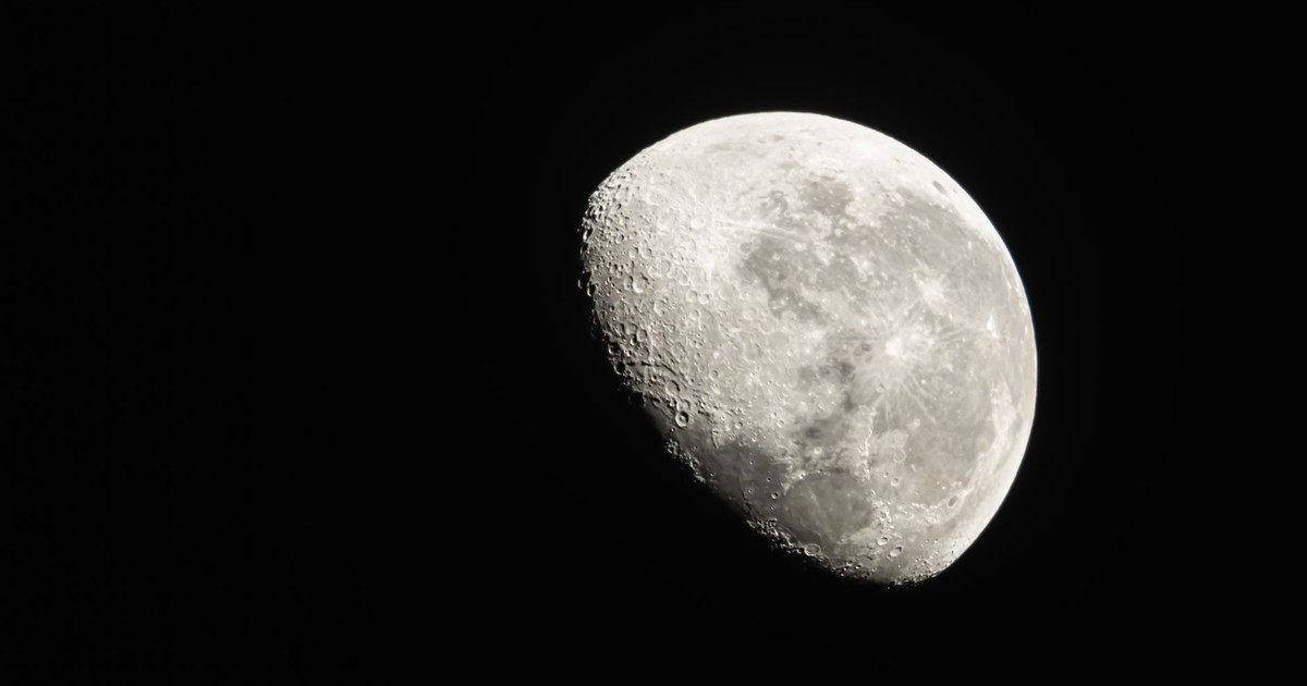 Detailed view of the Moon phase with visible craters against a dark night sky.