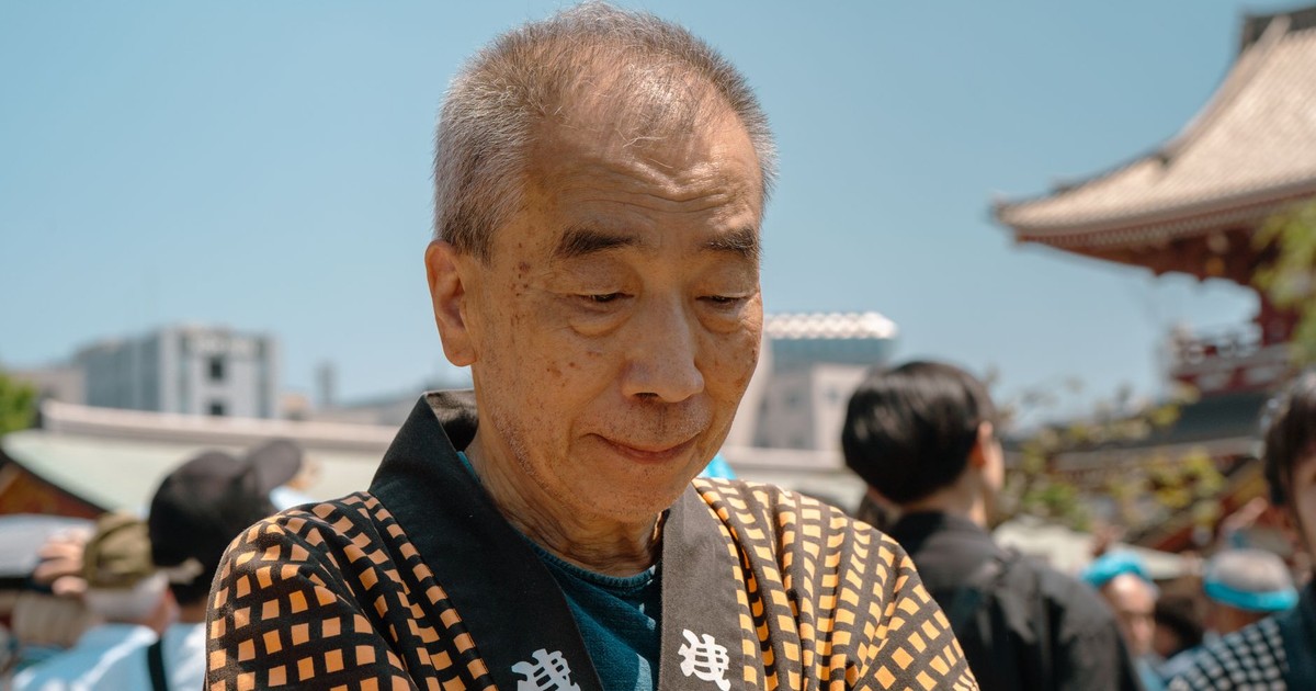 Elderly man in traditional Japanese attire at a festival in Tokyo, Japan. Vibrant and cultural scene.