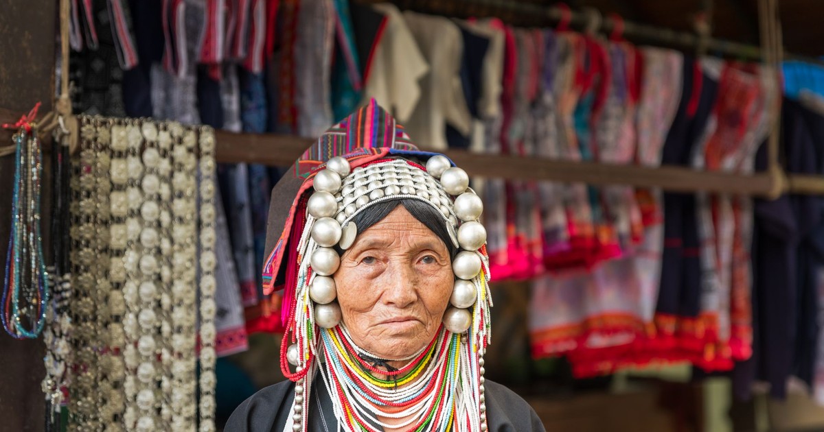 Elderly Akha woman in traditional attire at a market in Chiang Rai, Thailand.