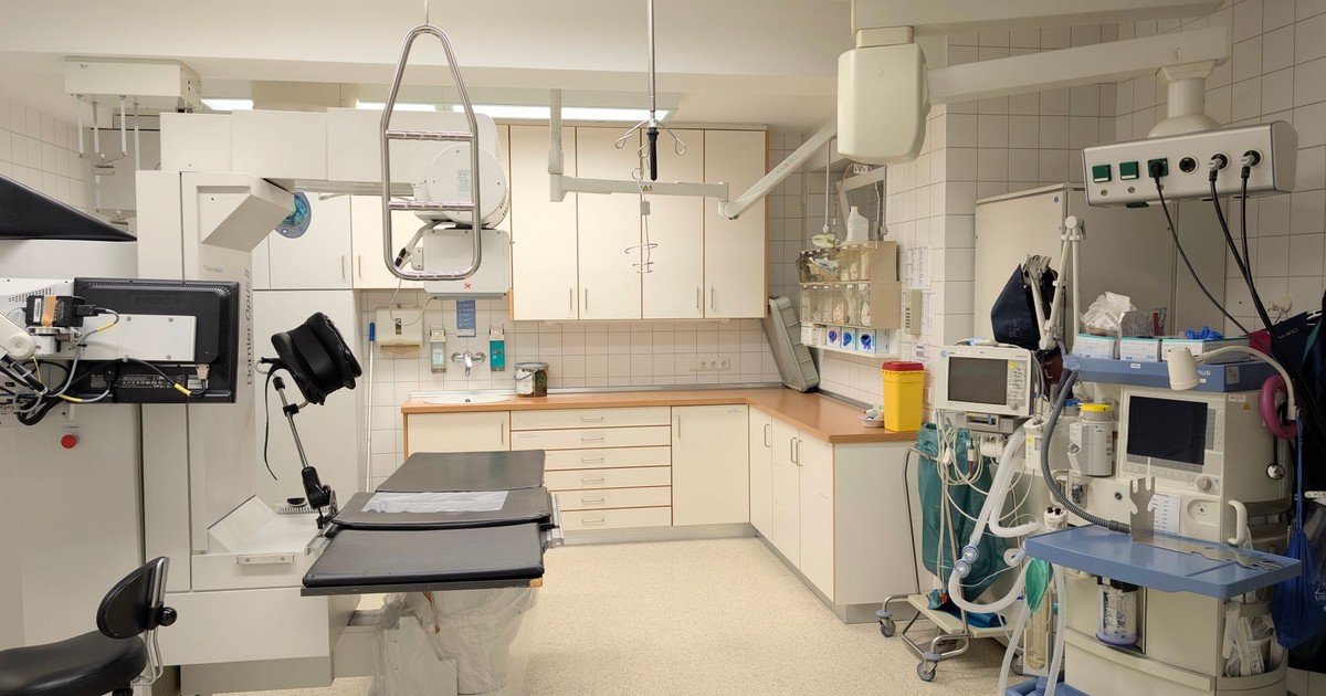 Spacious X-ray room equipped with advanced imaging technology in a hospital.