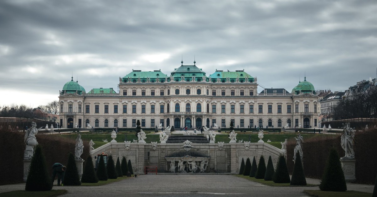 A front view of Belvedere Palace in Vienna, Austria against a moody sky.