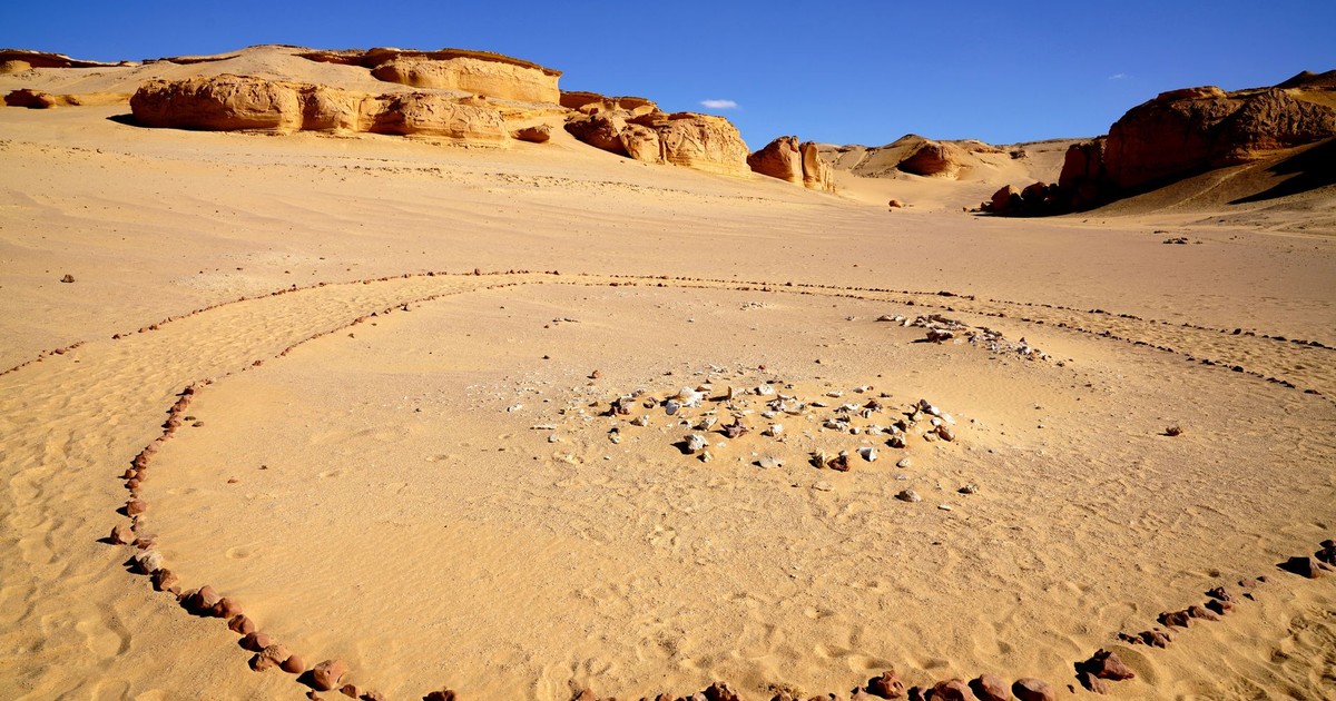 A captivating view of a stone circle in the Egyptian desert under a clear blue sky.