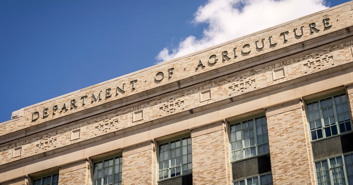 Close-up of the Department of Agriculture building facade under a clear blue sky.